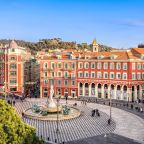 Aerial view of Place Massena square with red buildings  and fountain in Nice, France